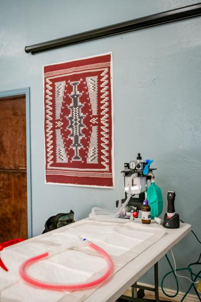 Table set up for a spay/neuter surgery with a woven Navajo rug hanging on the wall